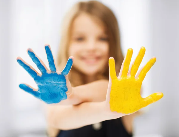 Girl showing painted hands — Stock Photo, Image