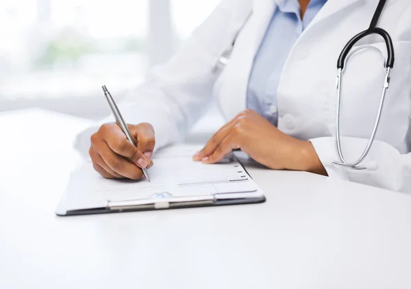 Médico feminino que escreve prescrição — Fotografia de Stock