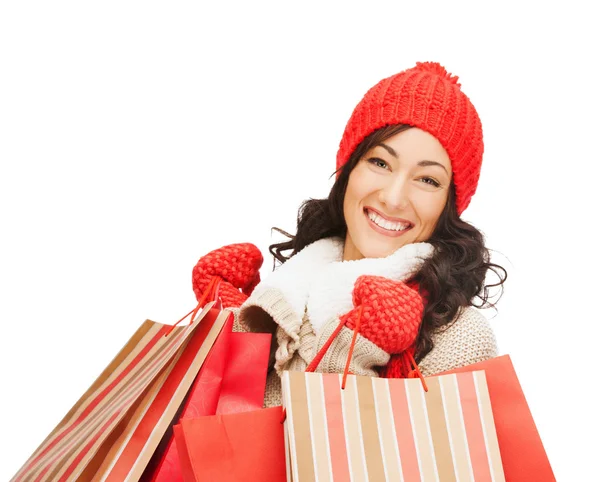 Mulher sorridente em roupas quentes com sacos de compras — Fotografia de Stock