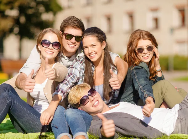 Group of students or teenagers showing thumbs up — Stock Photo, Image