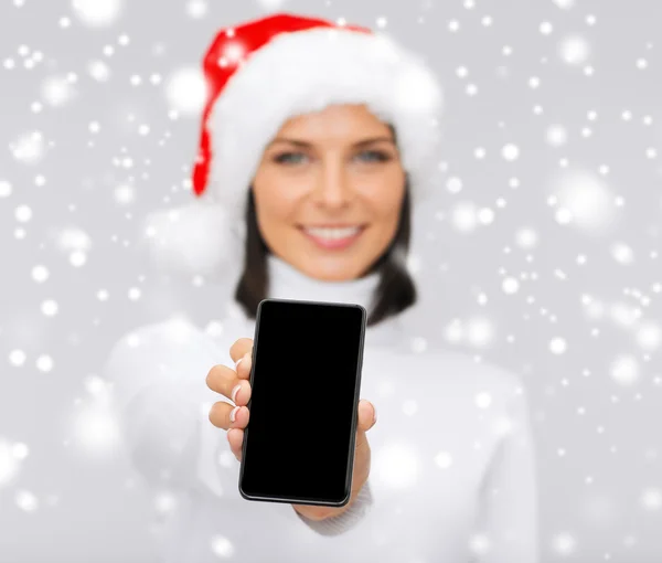 Usmívající se žena v pomocníka čepice santa s smartphone — Stock fotografie