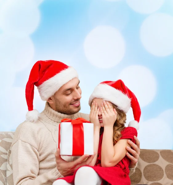 Smiling daughter waiting for a present from father — Stock Photo, Image