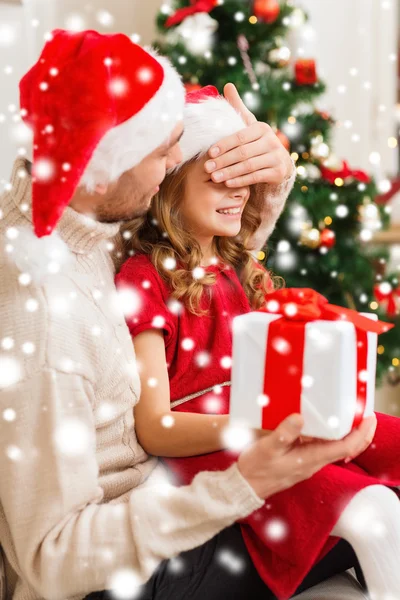 Smiling father surprises daughter with gift box — Stock Photo, Image