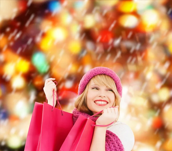 Mujer en sombrero rosa y bufanda con bolsas de compras —  Fotos de Stock