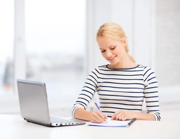 Smiling student with laptop computer and documents — Stock Photo, Image