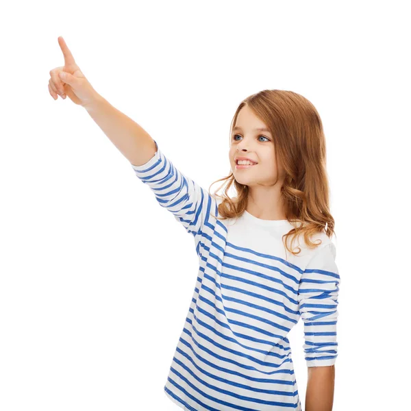 Smiling girl pointing at virtual screen — Stock Photo, Image