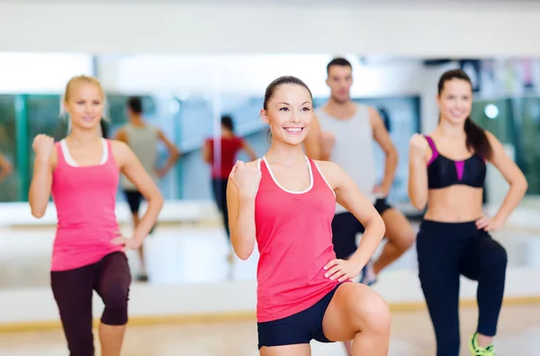 Grupp av leende människor tränar i gymmet — Stockfoto