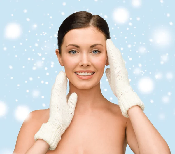 Smiling young woman in white mittens — Stock Photo, Image