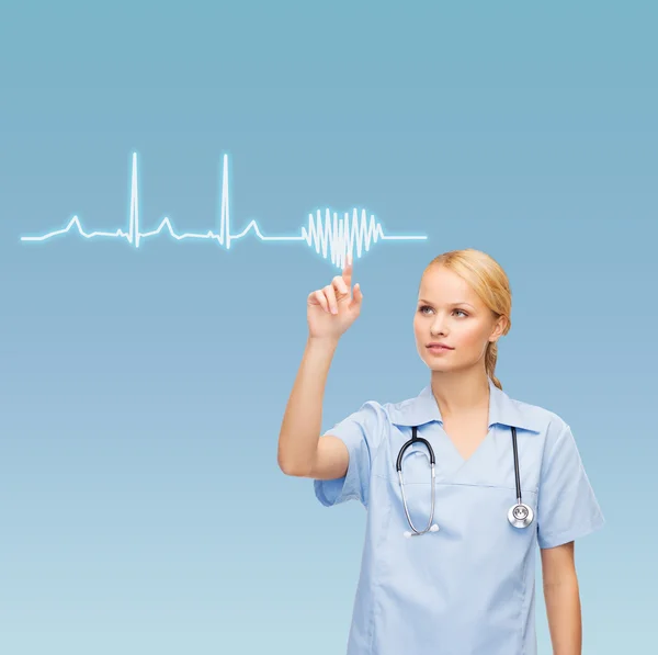 Smiling doctor or nurse pointing cardiogram — Stock Photo, Image
