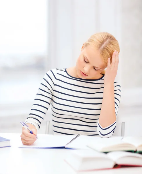 Concentrated woman studying in college Royalty Free Stock Photos