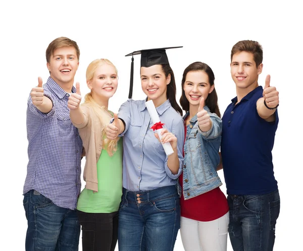 Group of students with diploma showing thumbs up — Stock Photo, Image