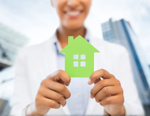 Woman hands holding green house — Stock Photo, Image
