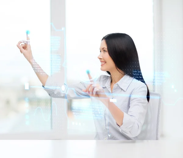 Smiling woman pointing to virtual screen — Stock Photo, Image