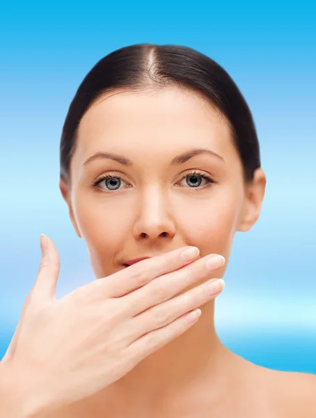 Beautiful woman covering her mouth — Stock Photo, Image