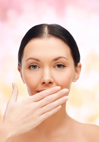 Beautiful woman covering her mouth — Stock Photo, Image