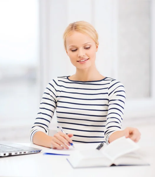 Smiling student with laptop computer and documents — Stock Photo, Image