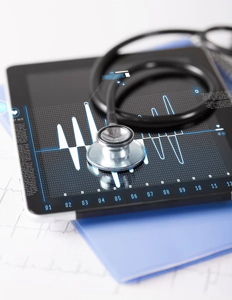 Tablet pc, stethoscope and electrocardiogram — Stock Photo, Image