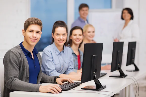 Students with computer monitor at school — Stock Photo, Image