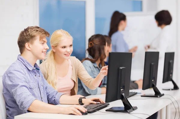 Students with computer monitor at school — Stock Photo, Image