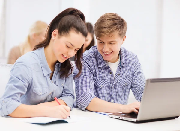 Students with laptop and notebooks at school — Stock Photo, Image