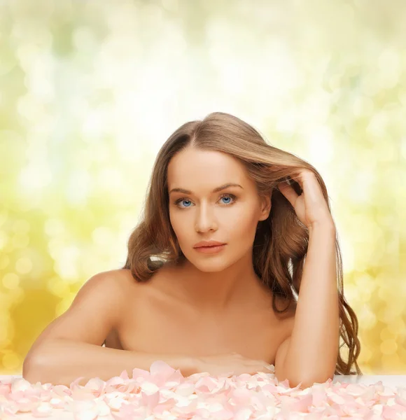 Woman with long hair and rose petals — Stock Photo, Image