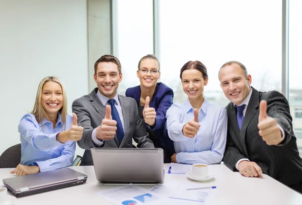 Business team showing thumbs up in office — Stock Photo, Image