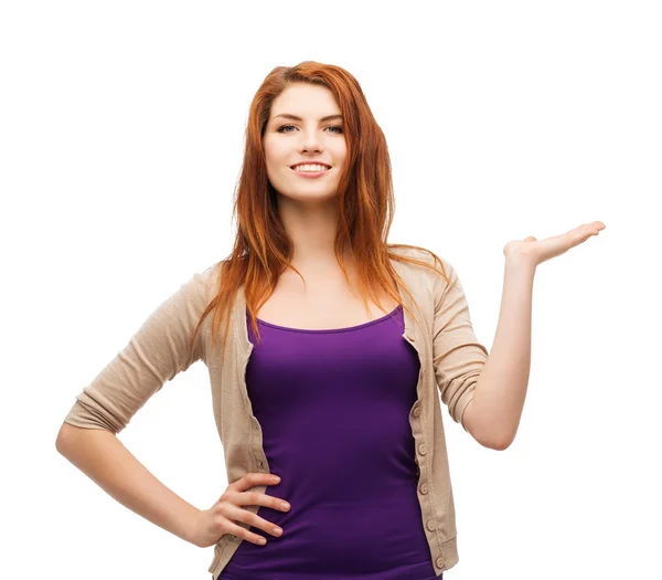 Teenager holding something on the palm of her hand — Stock Photo, Image