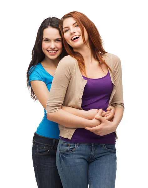 Two laughing girls hugging Stock Picture