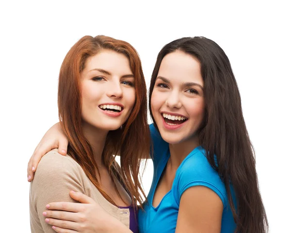 Two laughing girls hugging Royalty Free Stock Images