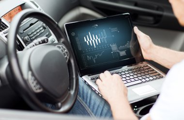 Man using laptop computer in car clipart