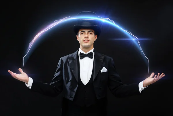 Magician in top hat showing trick — Stock Photo, Image