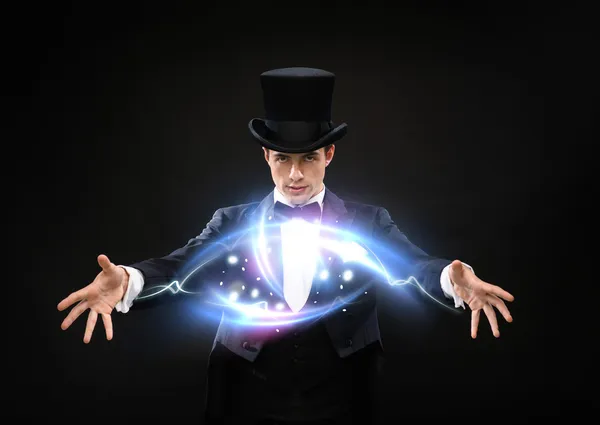 Magician in top hat showing trick — Stock Photo, Image