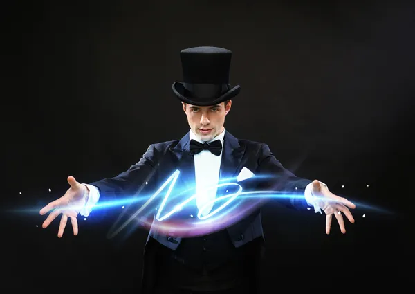 Magician in top hat showing trick — Stock Photo, Image