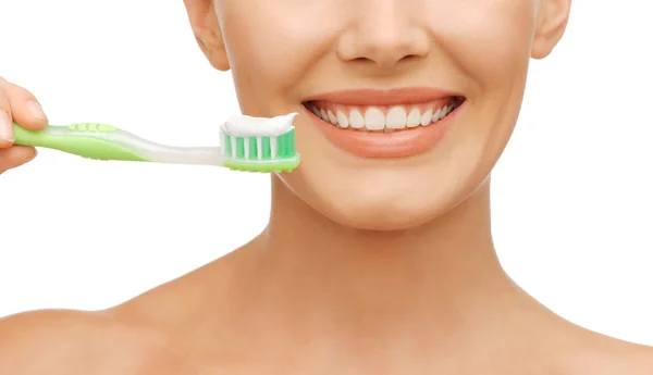 Frau mit Zahnbürste Stockfoto