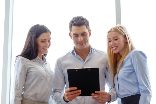 Business team looking at clipboard — Stock Photo, Image