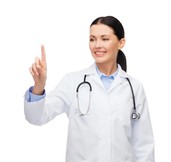 Smiling female doctor pointing to something Royalty Free Stock Photos