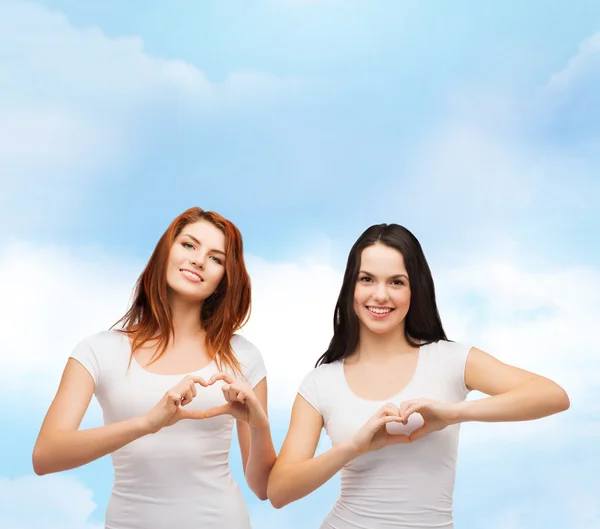 Two smiling girls showing heart with hands — Stock Photo, Image