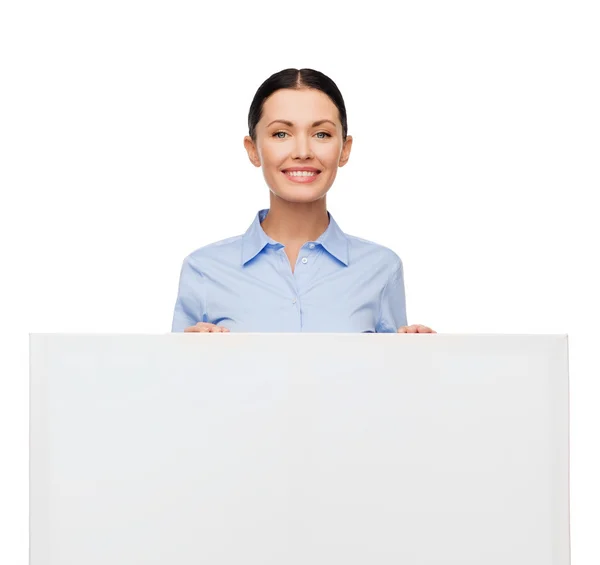 Smiling businesswoman with white blank board — Stock Photo, Image
