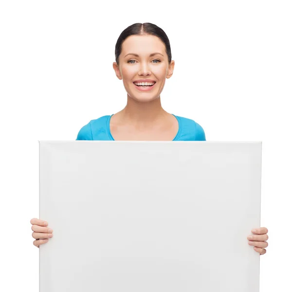 Smiling girl with white blank board — Stok fotoğraf