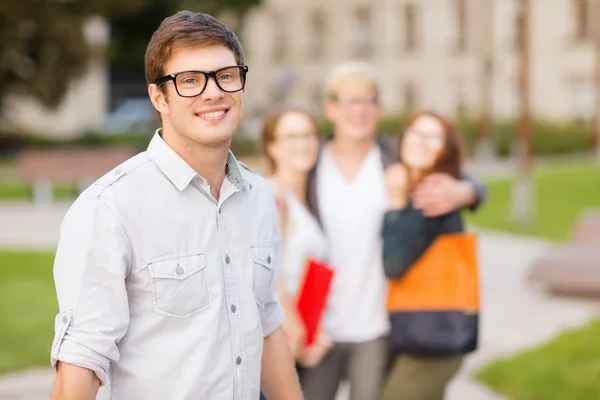 Teenage boy with classmates on the back — Stock Photo, Image