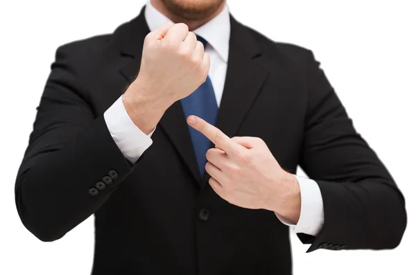 Businessman pointing to something at his hand — Stock Photo, Image