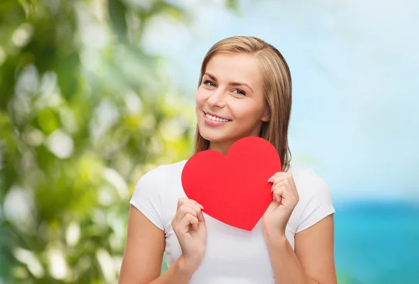 Smiling woman in white t-shirt with heart — Stock Photo, Image