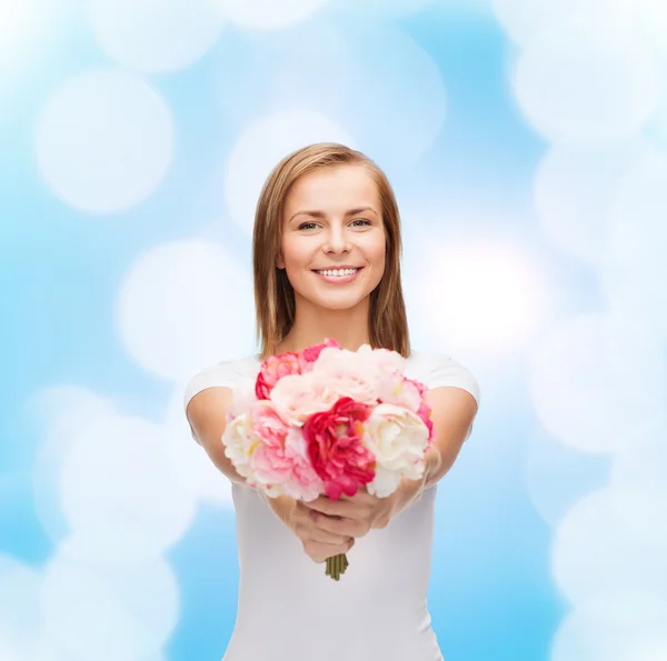 Femme souriante avec bouquet de fleurs — Photo