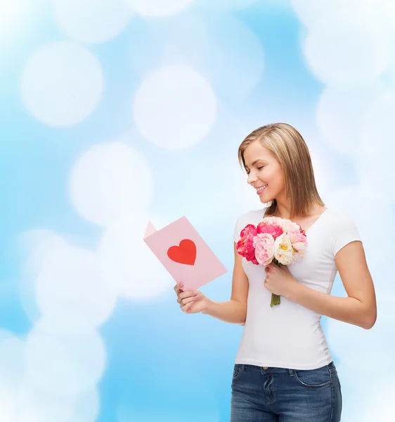 Smiling girl with postcard and bouquet of flowers Stock Picture