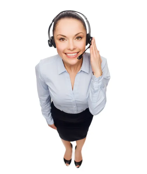 Friendly female helpline operator with headphones — Stock Photo, Image