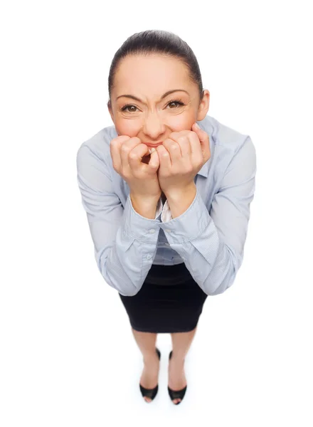 Frightened businesswoman biting her fingers Stock Image