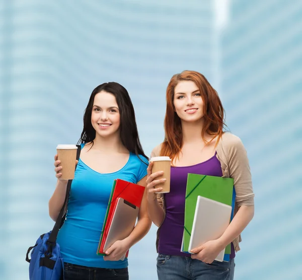 Dos estudiantes con bolsa, carpetas, tableta y café — Foto de Stock