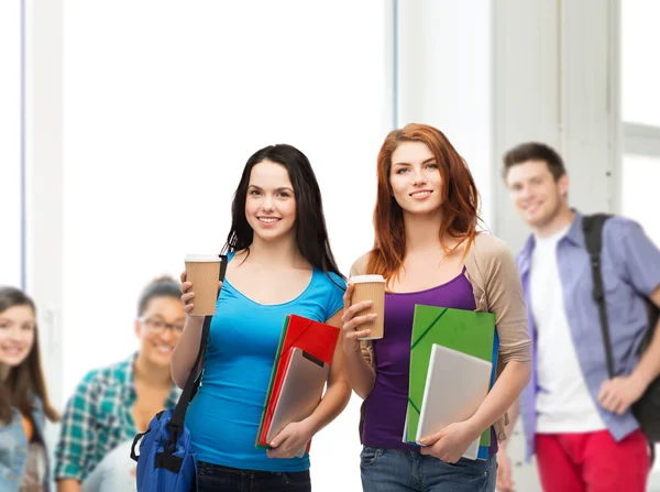 Two students with bag, folders, tablet and coffee — Stock Photo, Image