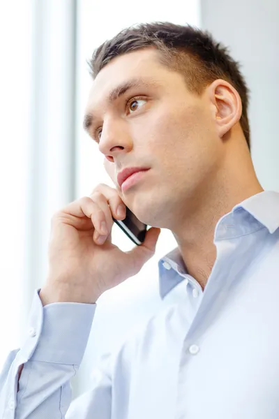 Serious businessman with smartphone — Stock Photo, Image