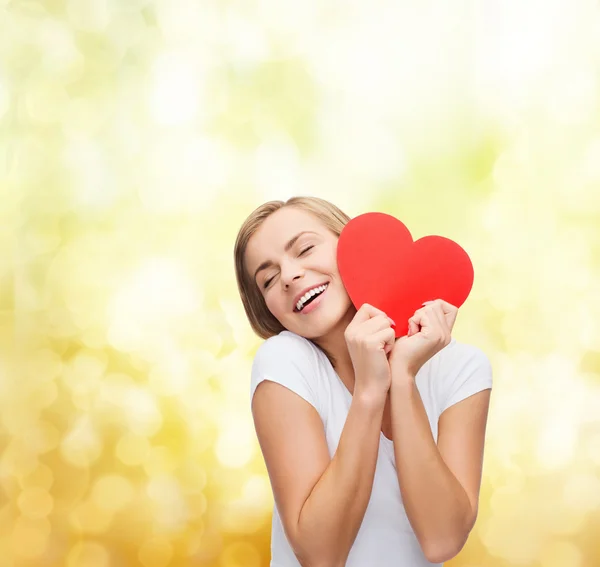 Smiling woman in white t-shirt with heart — Stock Photo, Image